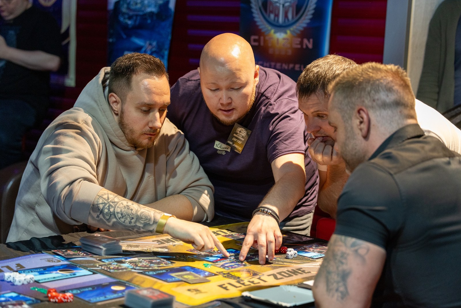 Players learning and playing STAR SQUADRONS together at a local event